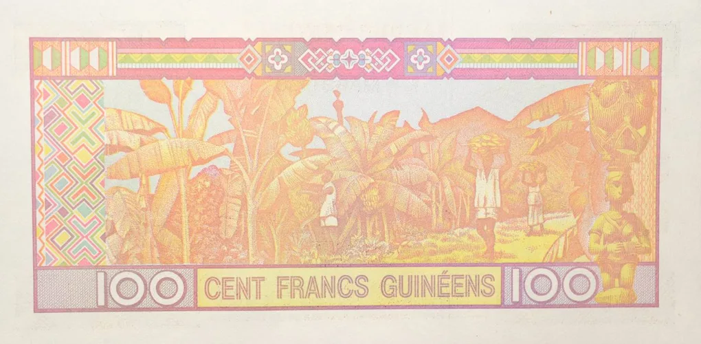 100 Francs of Guinea Country (AD 1998) with Peasant work scene in a plantation of bananas, with people harvesting fruits