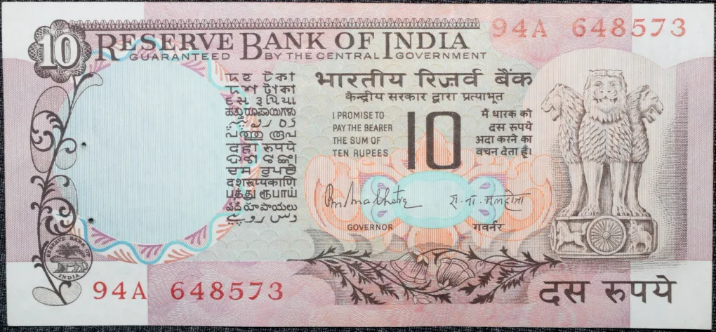 10 Rupees of Republic India (AD 1970-1990) with Two blue peacocks or Indian peafowl (Pavo cristatus) sitting on branches of an old mango tree surrounded by antelopes, horses, flowers, and a bird - R.N. Malhotra