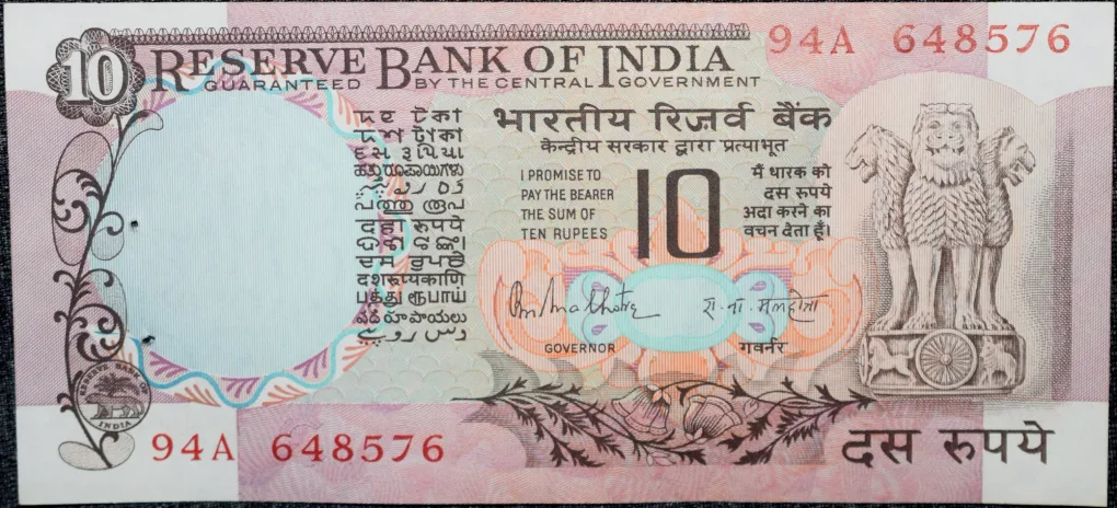 10 Rupees of Republic India (AD 1970-1990) with Two blue peacocks or Indian peafowl (Pavo cristatus) sitting on branches of an old mango tree surrounded by antelopes, horses, flowers, and a bird - R.N. Malhotra